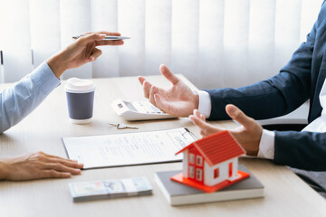 Real estate broker and client  sign contract insurance agreement document. Business meeting concept.