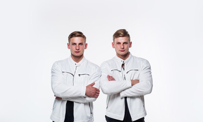 pure confidence. twins brother in white. male beauty and fashion. similar appearance