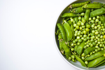 Bowl of healthy fresh organic green peas beans.