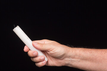 White candle on black background