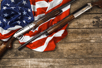 Automatic rifle on USA flag on wooden background