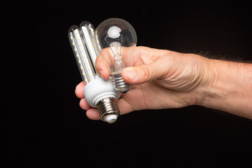 Light bulb in hand on a black background