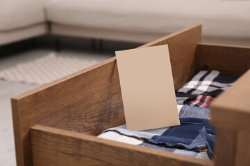 Scented sachet and folded clothes in drawer