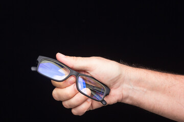 Glasses in the hand of a person