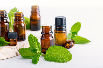 amber bottles with fresh mint leaves