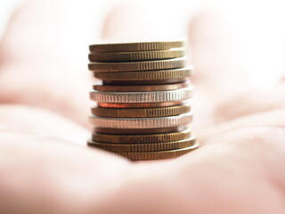 a stack of coins in a man's hand
