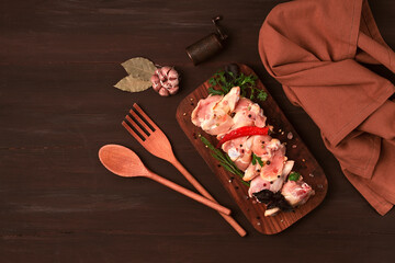 Obraz na płótnie Canvas Raw chicken joints, with spices, on a wooden table, top view, rustic style, no people,