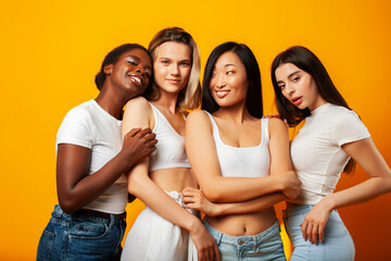 diverse multi nation girls group, teenage friends company cheerful having fun, happy smiling, cute posing on yellow background, lifestyle people concept, african-american, asian and caucasian