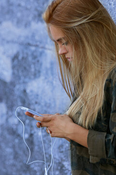 Oprofile View Of A Girl Using Her Smartphone In A Suburban Stree