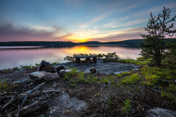 A campsite, complete with fire pit and a granite table top, on the shore of Eagle Lake, Northwest Ontario, Canada.