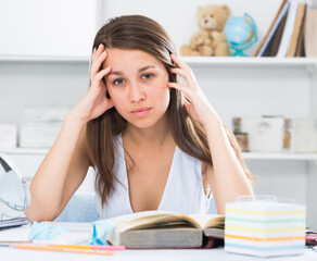 School girl is solving an equation at home.