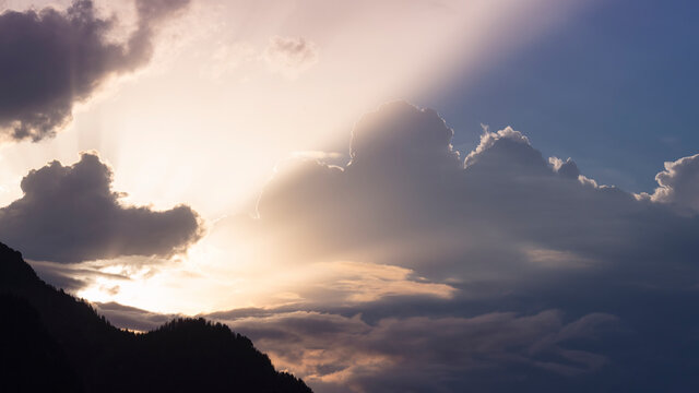 spectacular sunbeams through the splendor of clouds in an austrian mountain setting