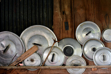 Pot lid on the wall of a Thai kitchen