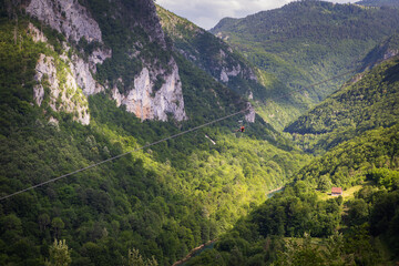 Extreme adrenaline rush in Montenegro, zipline. A steep and high descent above the river, a beautiful view of the canyon opens up.