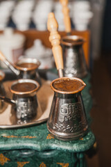 Turkish coffee brewed on sand in cezve. Oriental, east coffee
