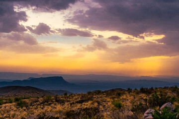 sunset through rain clouds in the mountains