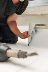 Worker specialized in mounting PVC membranes, TPO in the process of installing a water resistant...