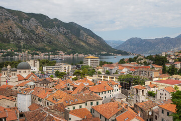 Naklejka na ściany i meble Beautiful top view of the old town of Kotor, Montenegro. Orange tiled roofs of houses from above.