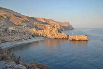 sunset panorama of the cliffs and La Rijana beach in Castell de Ferro in Granada in golden tones