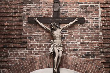 Сrucifixion of Jesus Christ on wooden cross. Thorn wreath on his head (concept of self-sacrifice,...