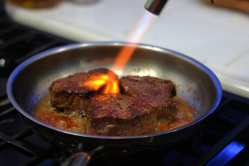 Cooking filet mignon on a stove
