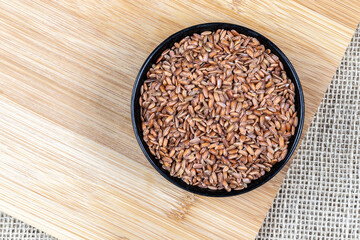 Close-up of red integral rice with selective focus on the wooden table in Brazil