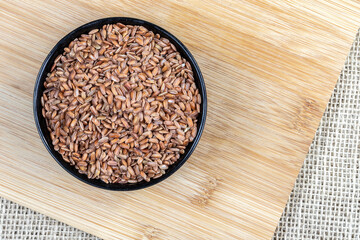 Close-up of red integral rice with selective focus on the wooden table in Brazil