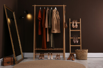 Modern dressing room interior with clothing rack and mirror