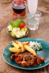 greek stifado meat stew with fries