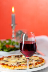 pizza with red wine and a candle