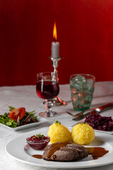 closeup of a german sauerbraten with dumplings
