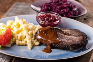 closeup of a german sauerbraten with dumplings