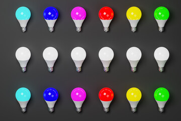 Lighted bulbs of different colors of the chromatic range on a dark background. 3d Render. - 446311464