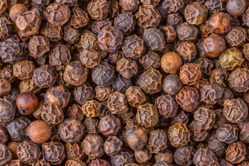 Large pile of allspice peas. Food background.Background made of middle eastern traditional spice . Top view.Textures of colorful spices and condiments.