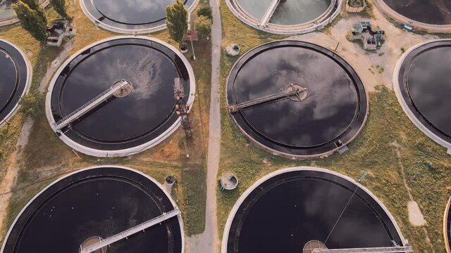 Aerial view of the solid clarifier tank type sludge recirculation in water treatment plant in near big city. Wastewater treatment plant