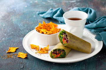 Tortilla coconut moringa wraps sandwiches with fresh vegetables, meat and homemade pumpkin chips. Burrito, fajita wrap, sandwich wrap.
