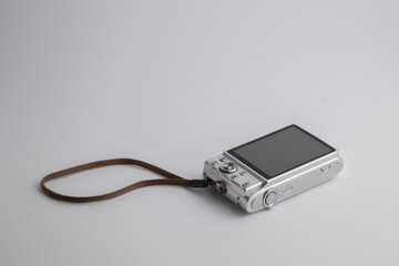 A used digital pocket camera on white background