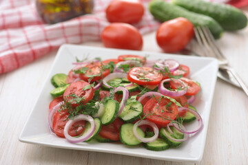 Fresh vegetable salad with cucumber, tomato and red onion