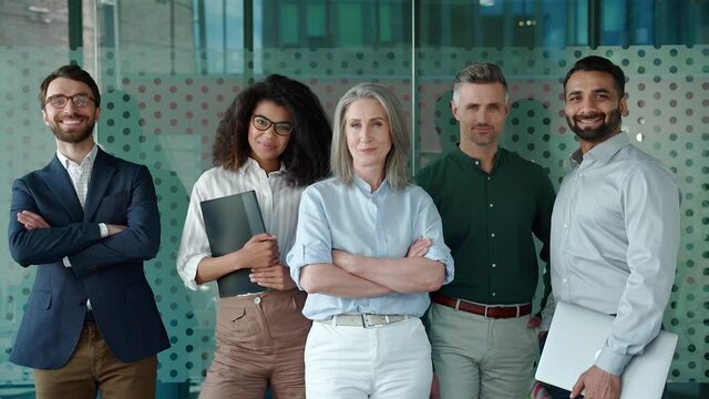 Happy Diverse Business People Office Workers Team Standing In Row Looking At Camera. Multiethnic Professional Employees Executives Group Posing Together For Corporate Portrait, Leadership. Slow Motion