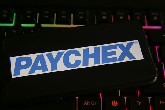 Viersen, Germany - June 1. 2021: Closeup of phone screen with logo lettering of paychex on computer keyboard