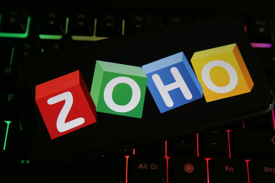 Viersen, Germany - June 1. 2021: Closeup of phone screen with logo lettering of zoho corporation on computer keyboard
