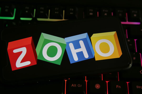 Viersen, Germany - June 1. 2021: Closeup of phone screen with logo lettering of zoho corporation on computer keyboard