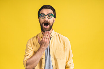 Happy winner! Portrait of shocked amazed young male man keeps mouth widely opened, being surprised,...