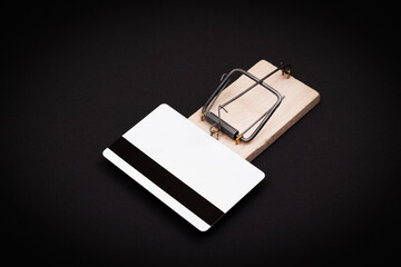 Credit Risk and Loan Trap - White Blank Credit Card Template in Wooden Mouse Trap on Black Background