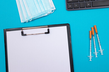 Vaccination, Immunology or Revaccination Concept - Three Insulin Syringe Lying on Blue Table in...