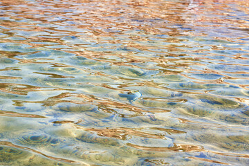 Fototapeta na wymiar Rippled water surface with reflection. Vacation and summer holiday