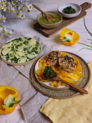 French-style potato salad and chicken cutlets on a light wooden table