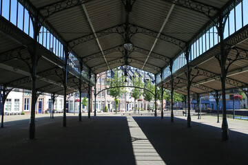 Helmond, Netherlands - July 10. 2021: View on open empty market hall construction, old dutch houses...