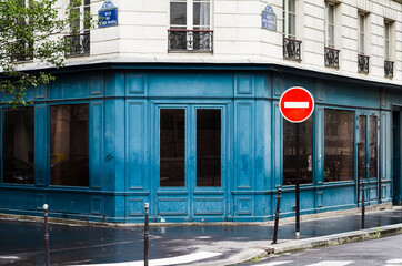 A classic blue building at the intersection of Rue de l'Ave Maria and rue des Jardins St. Paul in...