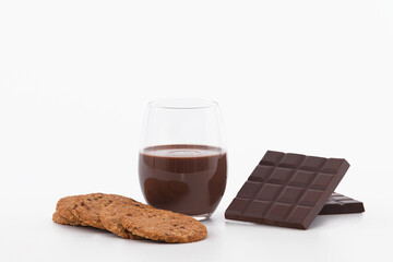 Glass of chocolate milkshake with cookies and chocolate bars: Selective focus. Chocolate concept
